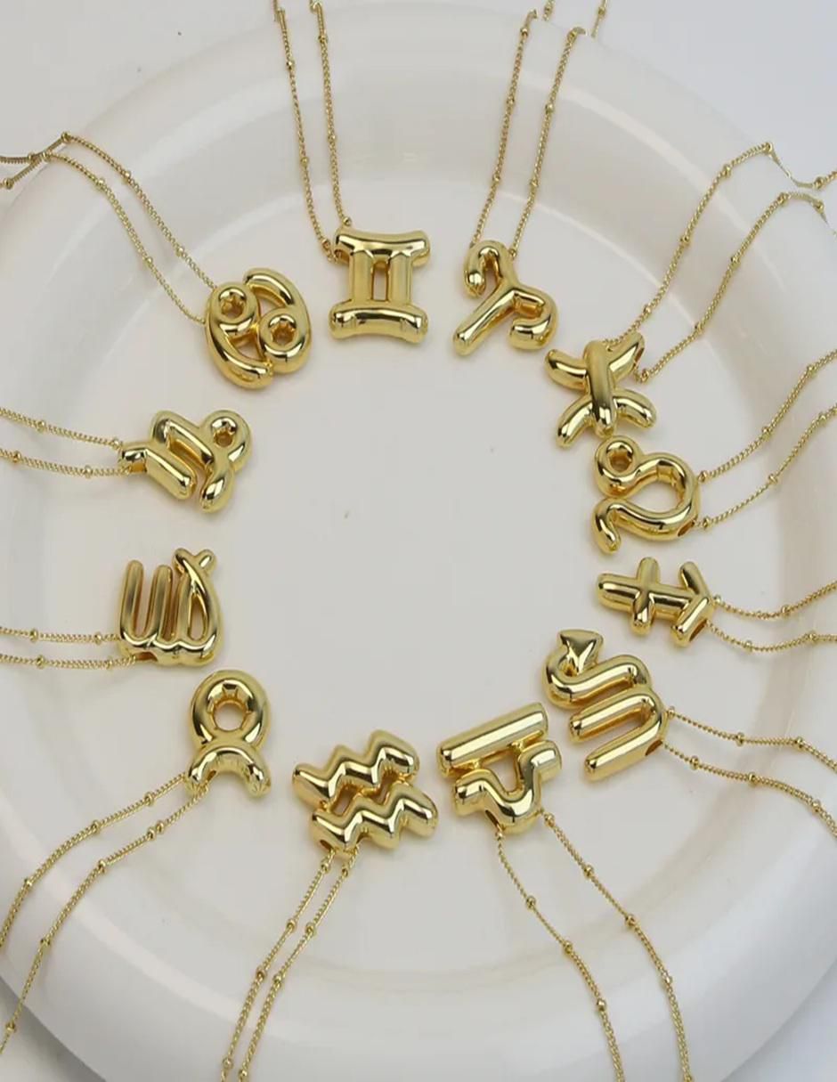 Collar con dije de signo zodiacal de oro laminado